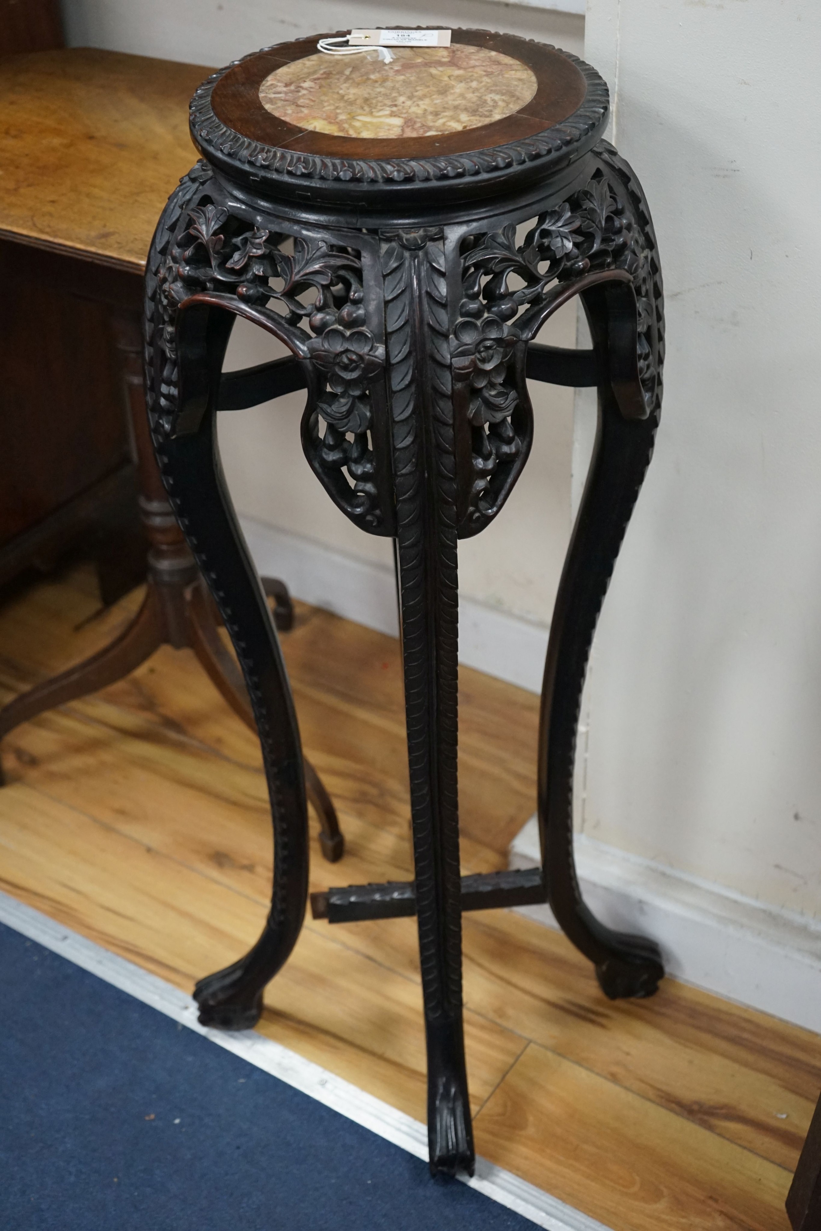 A Chinese circular marble top carved padouk jardiniere stand, height 91cm